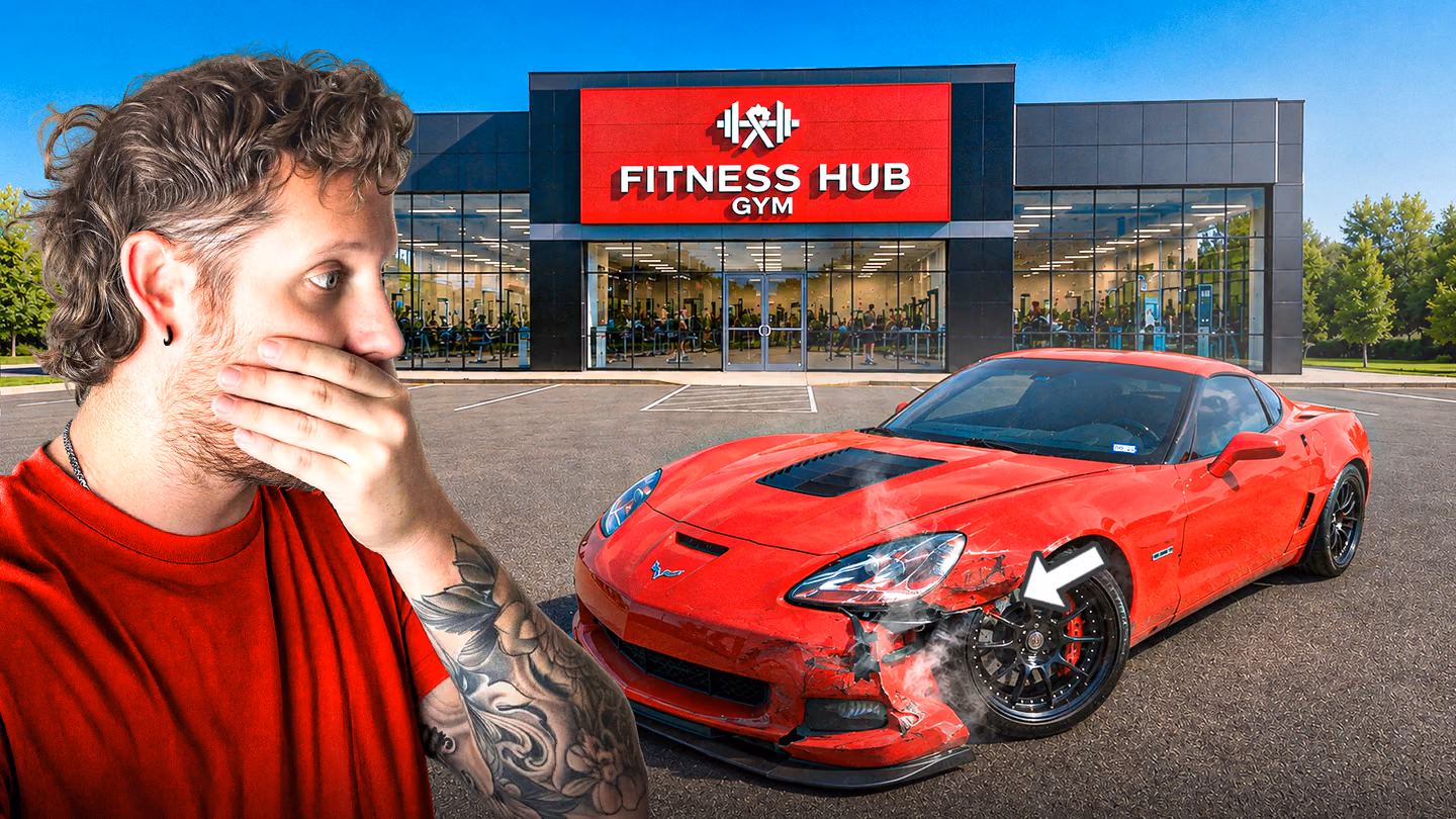 A shocked man looks toward a damaged red sports car parked outside a gym.
